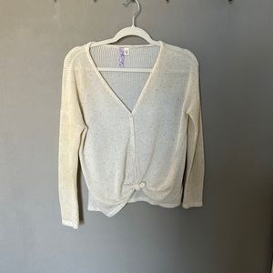 Off-white sweater with multi-color detailing. Button-up and knot detail